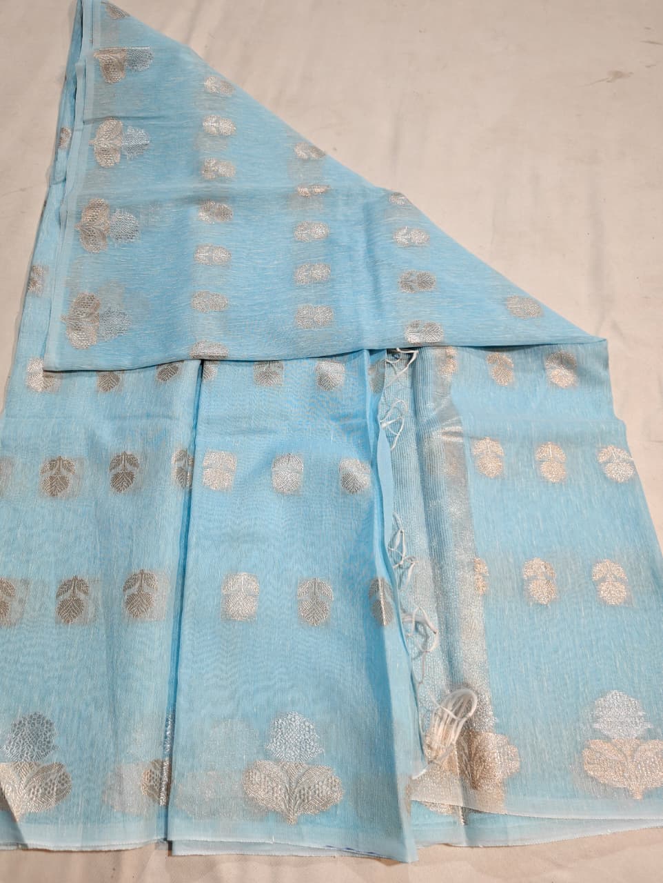 sky blue linen cotton saree with silver zari motifs